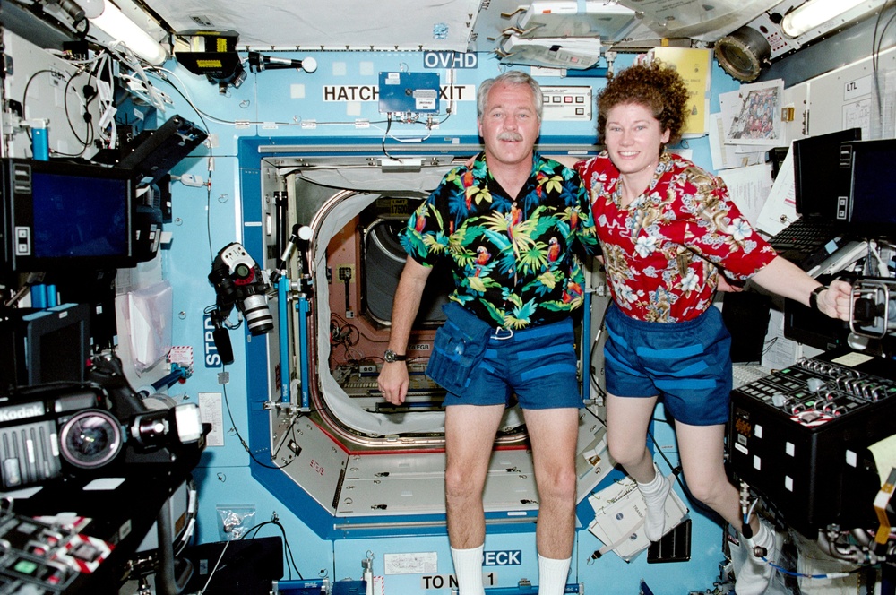 MS Phillips and Flight Engineer Helms pose for a  photo in the U.S. Laboratory