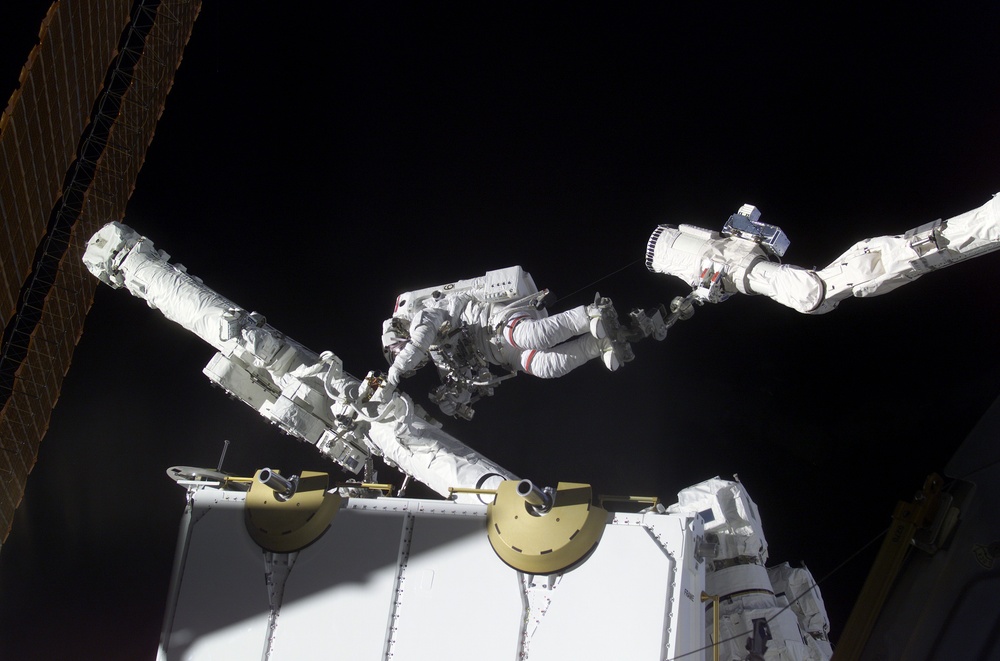MS Hadfield works on the SSRMS in the SLP during the first EVA for STS-100