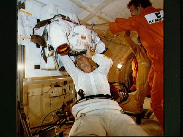 Spacsuit donning and doffing in zero-g training for Story Musgrave STS-6