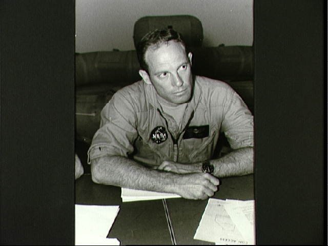 Astronaut Jack Lousma at table with crew and flight surgeon before training