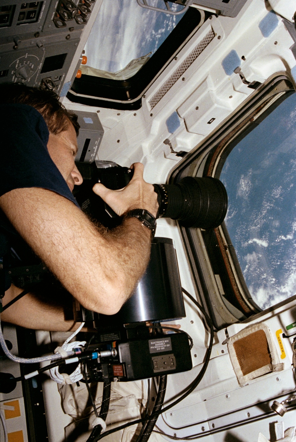 Crewmember in the aft flight deck with the HERCULES camera system.
