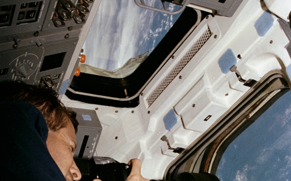 Crewmember in the aft flight deck with the HERCULES camera system.