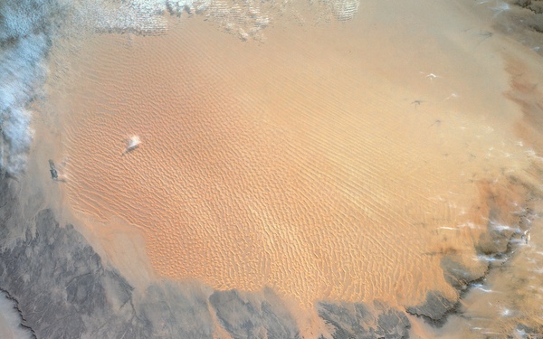 During STS-54 IUS/TDRS is released from cradle/tilt table above OV-105's PLB