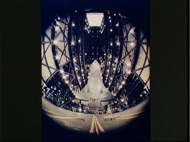 Fisheye view of the Columbia being lifted above the floor of the VAB