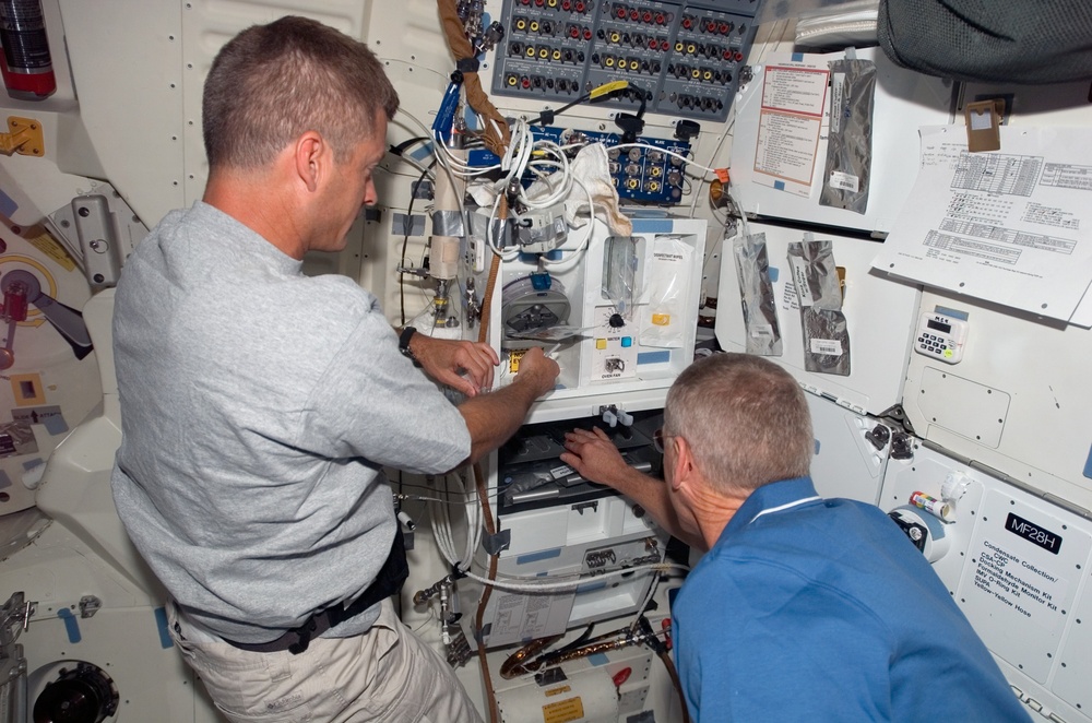 Swanson and Forrester prepare a meal in the FWD MDDK during Joint Operations