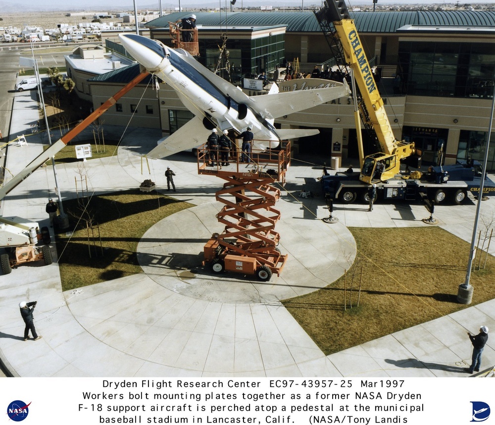 Retired NASA F-18 being mounted on pedestal mount at Lancaster California Municipal Baseball Stadium