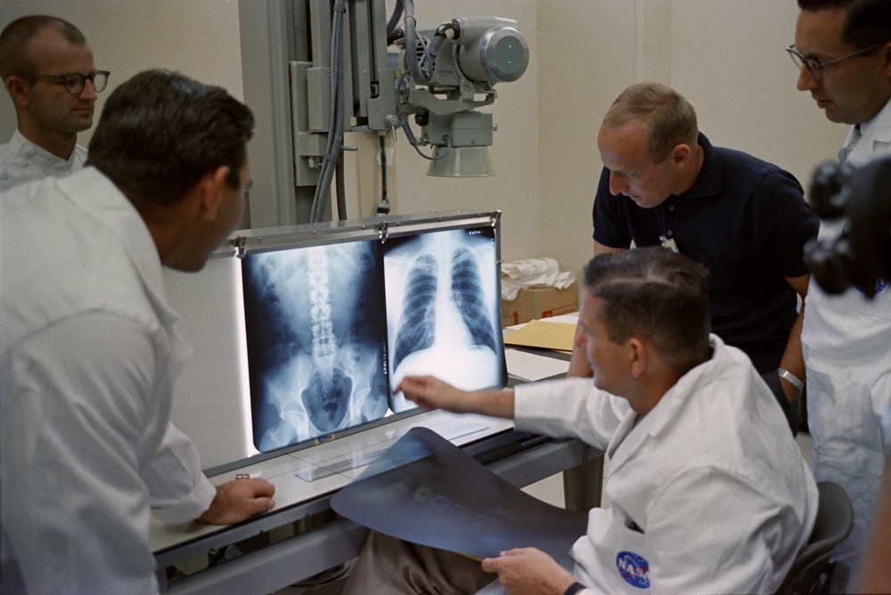 Astronaut Charles ''Pete'' Conrad, Jr. discusses x-rays with members of the medical team