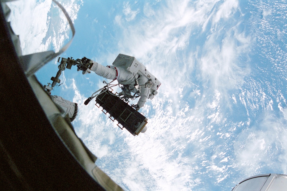 Thomas on the RMS arm transports the External Stowage Platform (ESP)