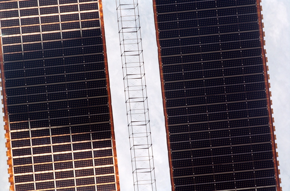 Exterior view of ISS during flyaround by STS-105 showing P6 SAW