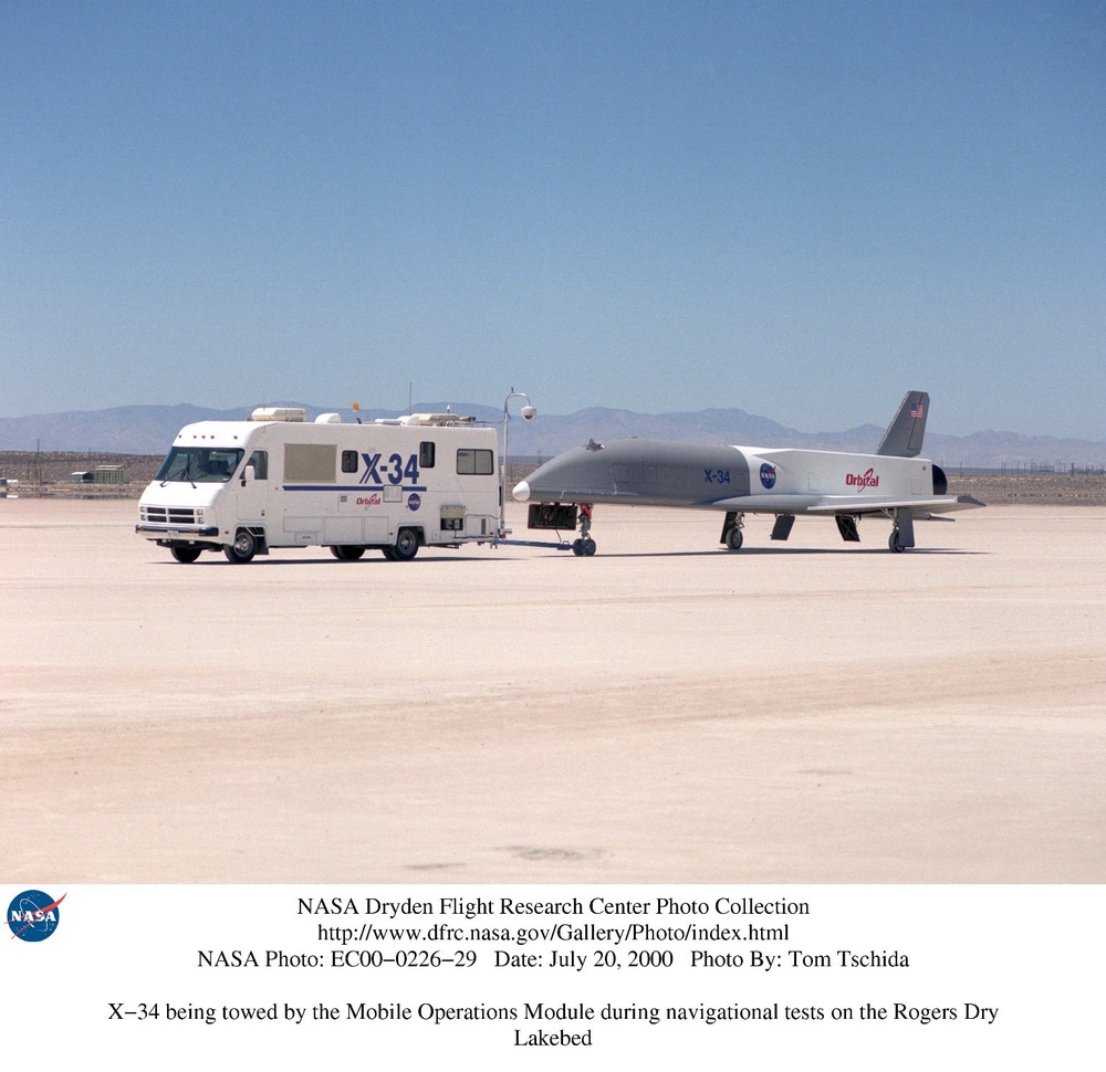 X-34 being towed by the Mobile Operations Module during navigational tests on the Rogers Dry Lakebed