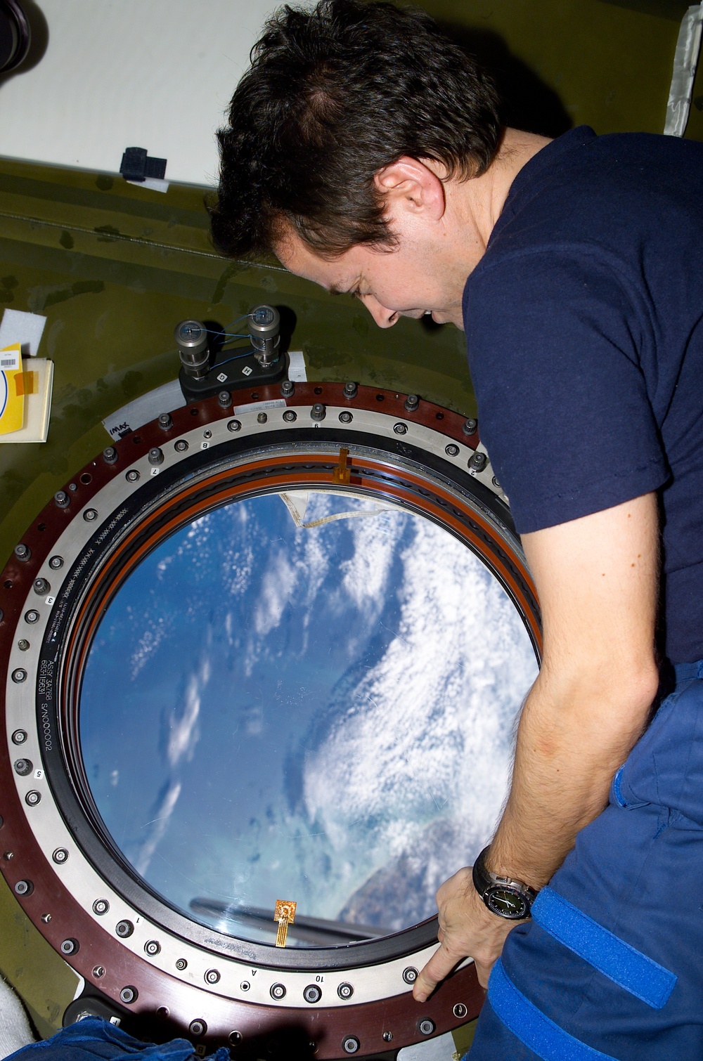 Bursch looks out the nadir window of Destiny during STS-110's visit to the ISS
