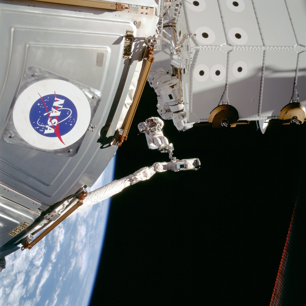 MS Hadfield works on the SSRMS during the first EVA for STS-100