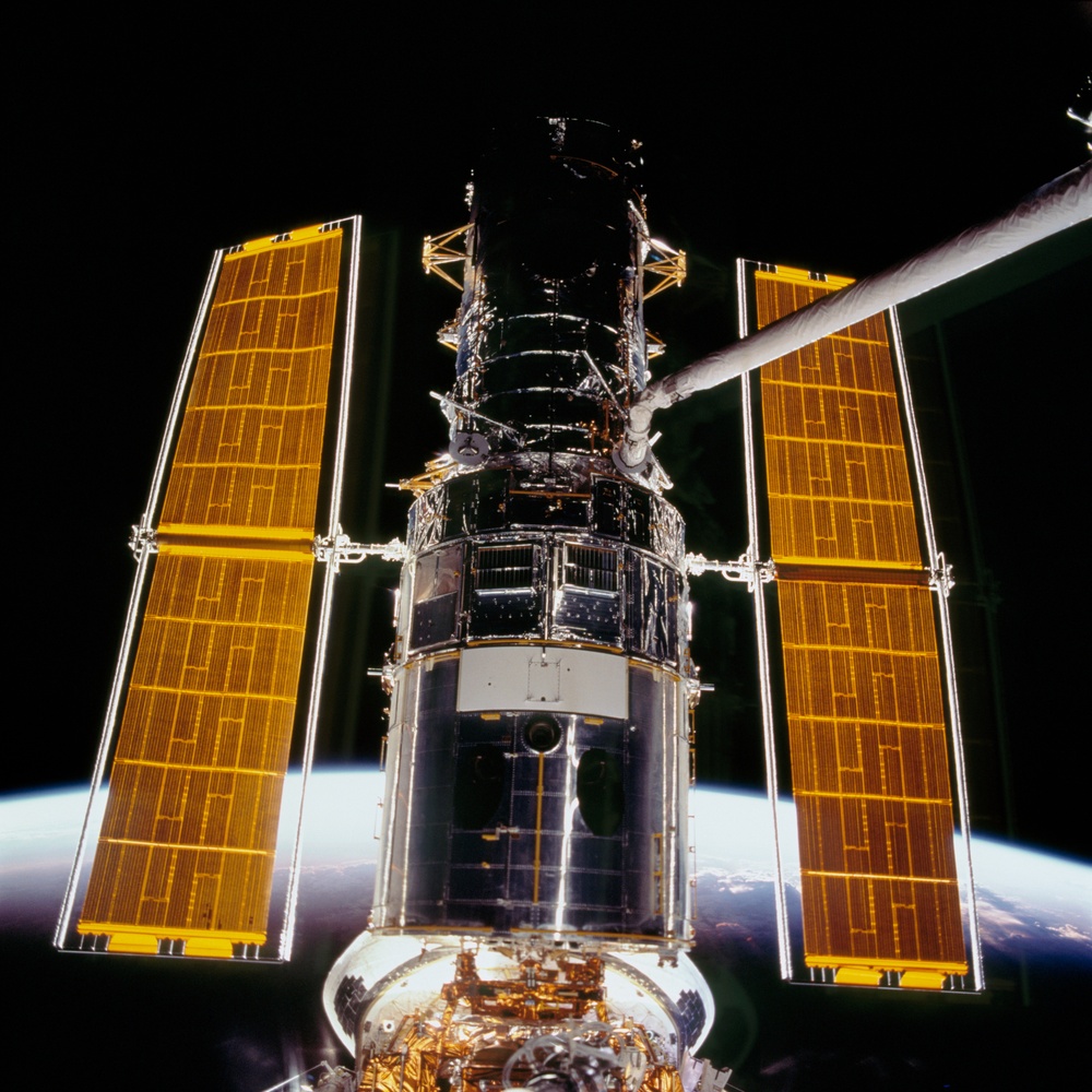View of Hubble being grappled by the STS-109 crew at sunset