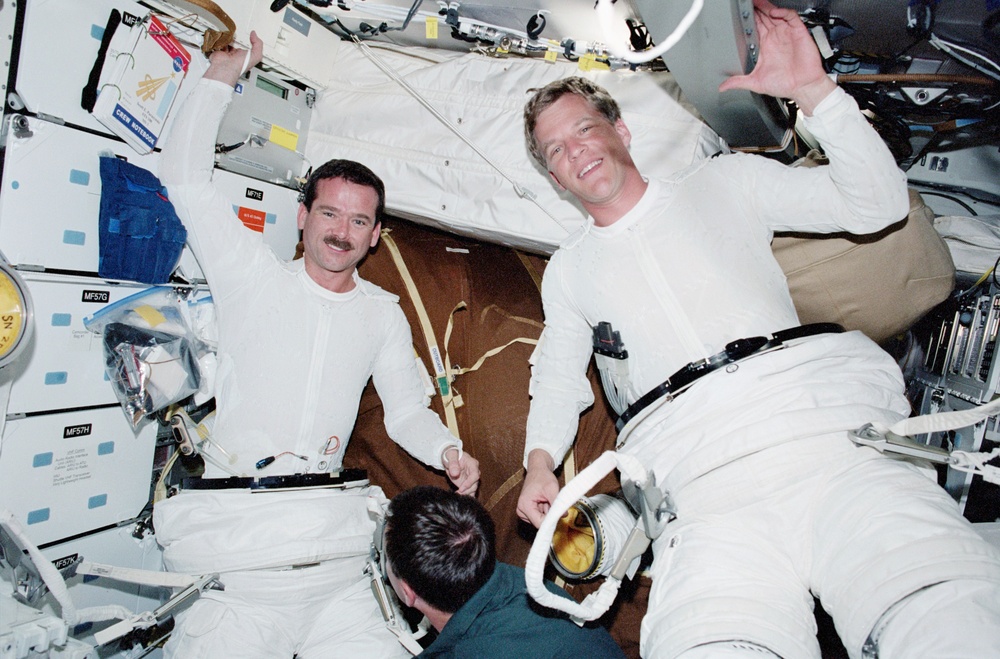 Lonchakov helps Hadfield and Parazynski prepare for the first EVA of STS-100