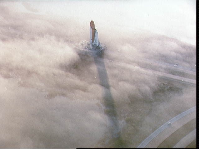 Two views of the "Challenger" being rolled out to pad 39A in the fog STS-6