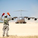 Service member guides C-17 onto landing zone