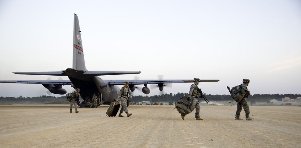 Military personnel offload C-130J
