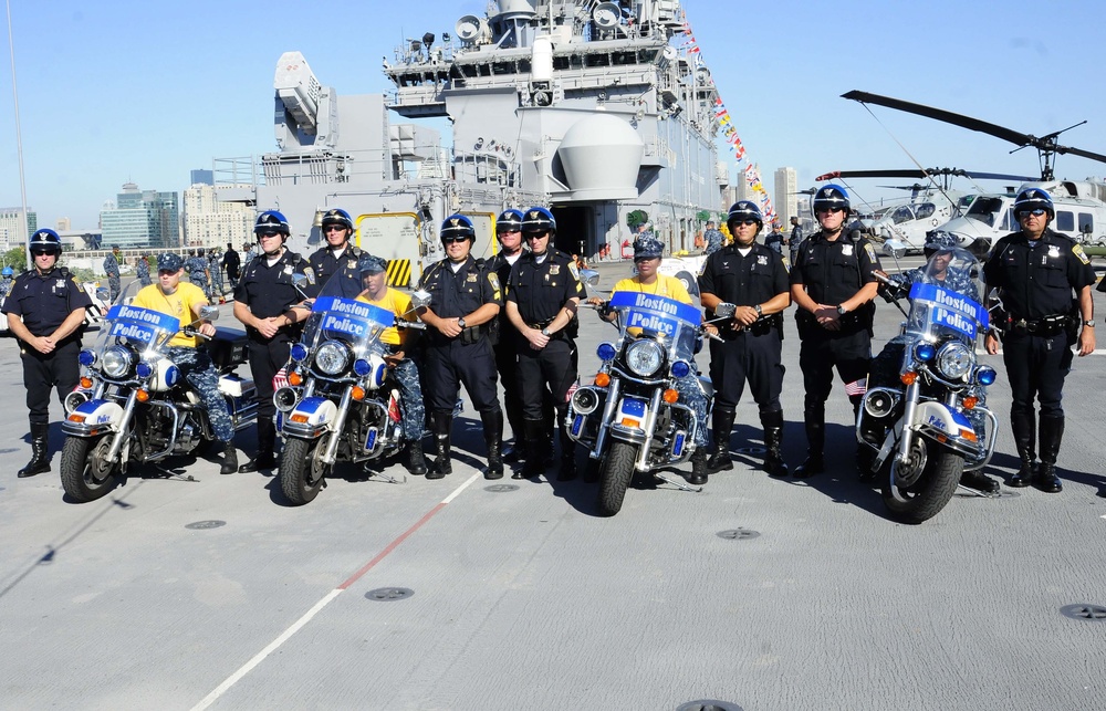Wasp sailors sit on Boston police motorcycles