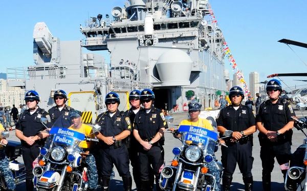 Wasp sailors sit on Boston police motorcycles