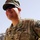 Sgt. Nikko Moreno smiles during training in southern Afghanistan A U.S. Army Sergeant is photographed outdoors in a forward operating environment, wearing MultiCam (OCP) camouflage uniform with an ISAF (International Security Assistance Force) patch on the right shoulder. The soldier is smiling and appears relaxed, standing with hands on hips in what appears to be a deployed setting consistent with operations in Afghanistan. The uniform displays a 'U.S. ARMY' tape, a name tape reading 'MIREN' (or similar), and Sergeant rank insignia.