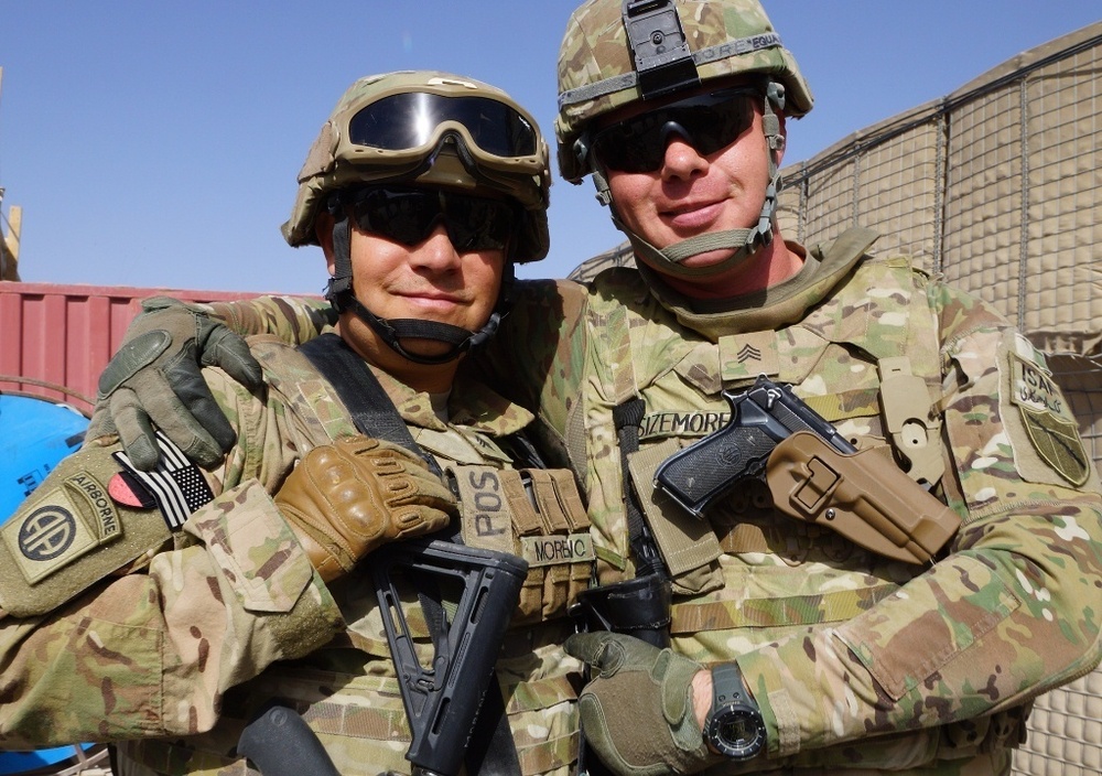 Two Kentucky soldiers embrace for a photo together in southern Afghanistan