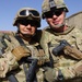 Two Kentucky soldiers embrace for a photo together in southern Afghanistan