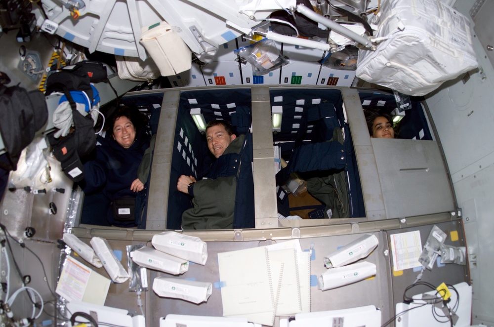 Clark, Husband, and Chawla in their sleep compartments on Columbia's MDK during STS-107