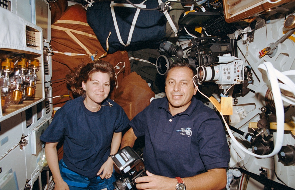 STS-93 Tognini and Coleman take photographs on the middeck of Columbia