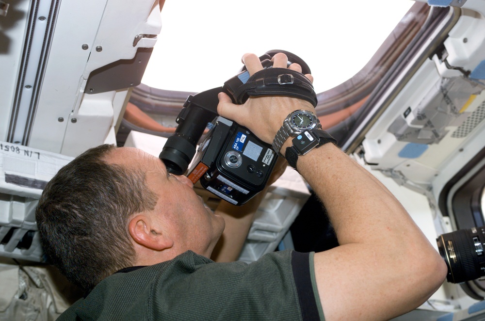 Brown holding a video camera on Columbia's AFD during STS-107