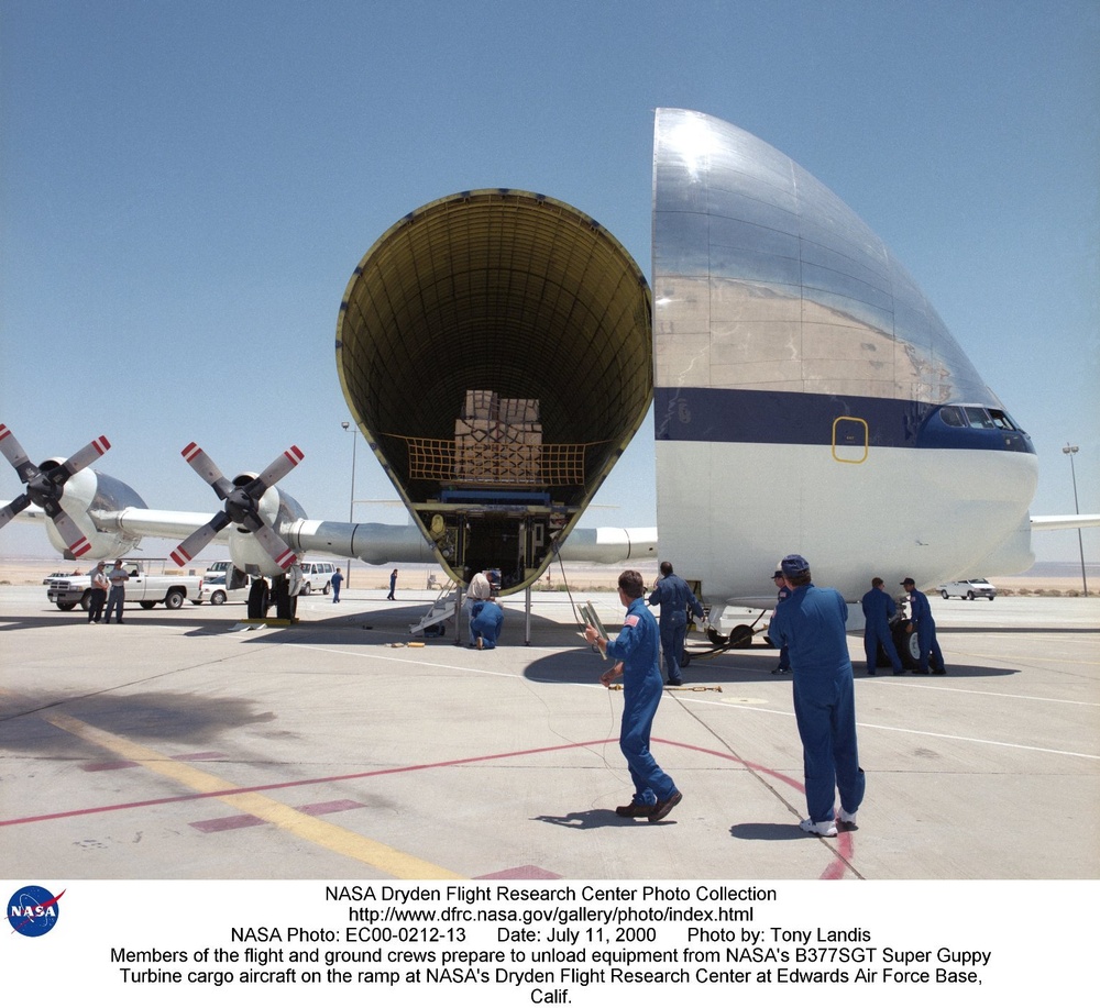 Members of the flight and ground crews prepare to unload equipment from NASA's B377SGT Super Guppy T