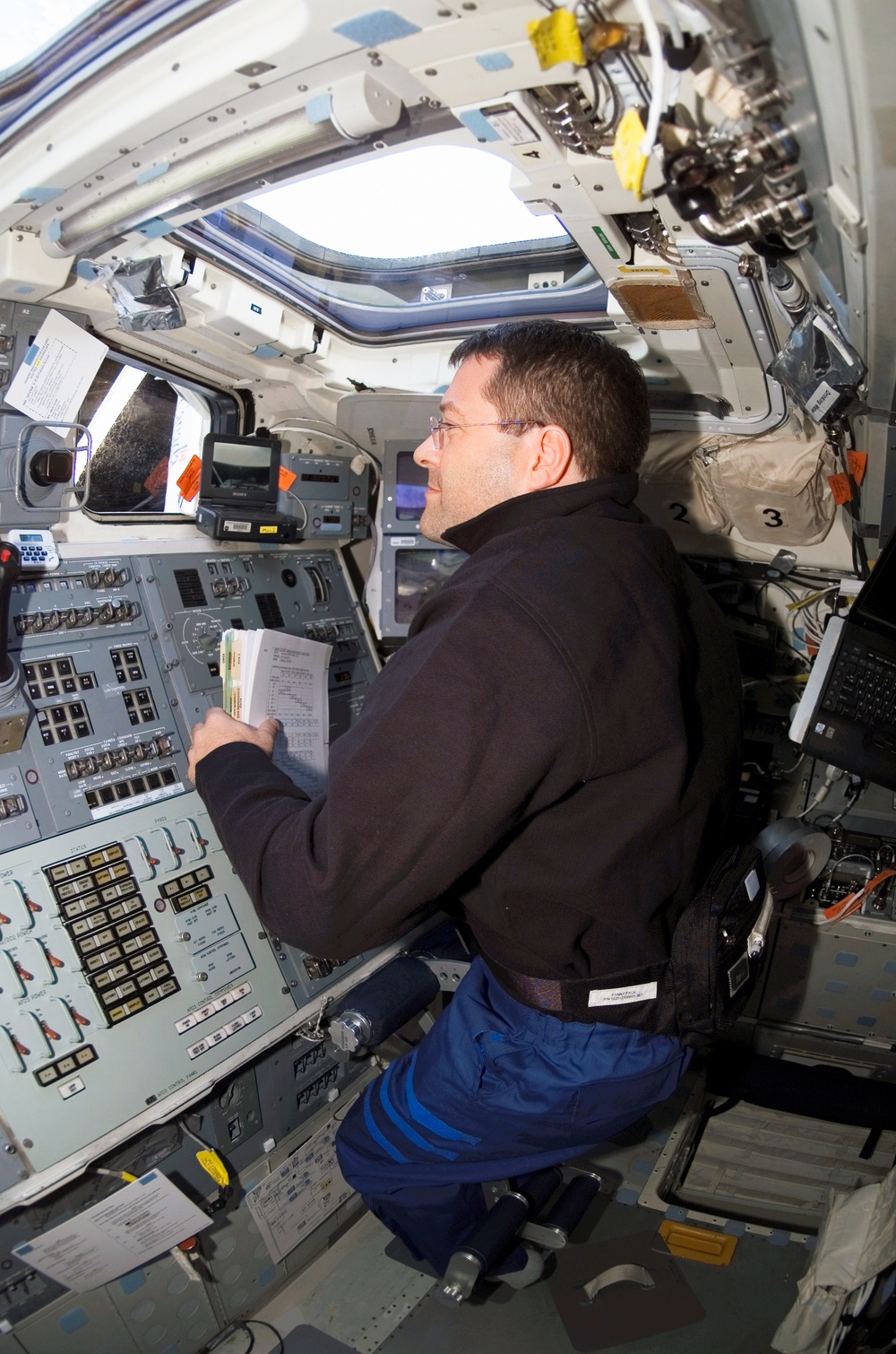 STS-116 MS Patrick looks out window in the aft FD on Space Shuttle Discovery