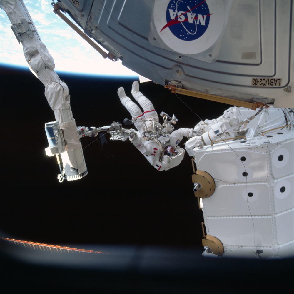MS Hadfield works on the SSRMS during the first EVA for STS-100