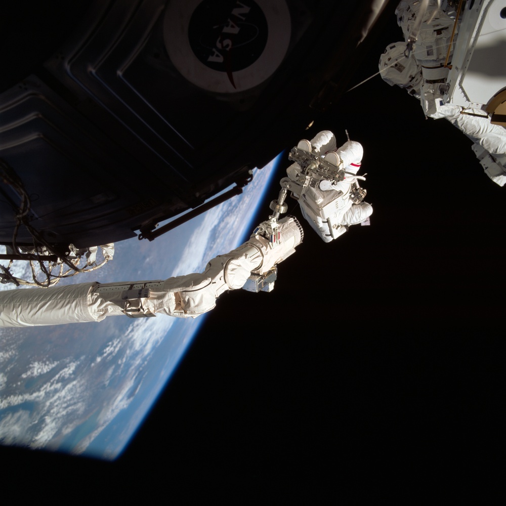 MS Hadfield works on the SSRMS during the first EVA for STS-100