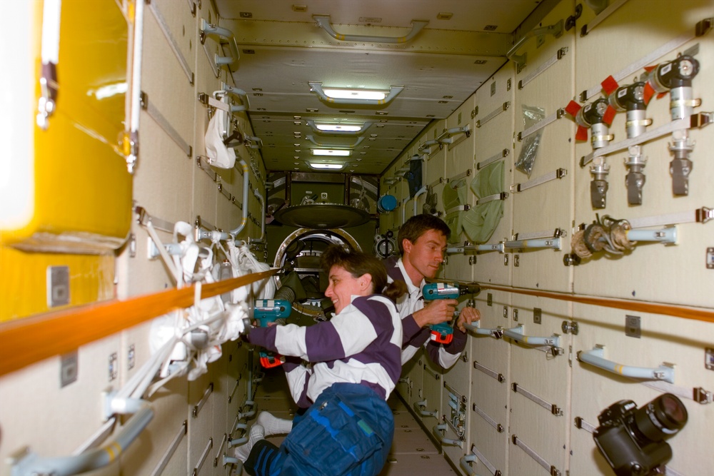 Currie and Krikalev remove launch restraint bolts in FGB/Zarya module