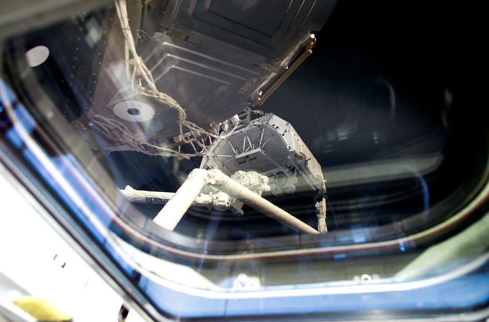 MS Hadfield works at the RMS controls on the flight deck of Endeavour during RMS handshake
