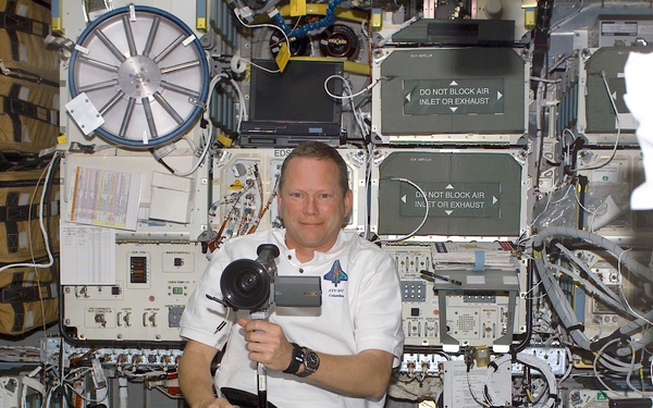 Brown with a video camera in the Spacehab RDM during STS-107