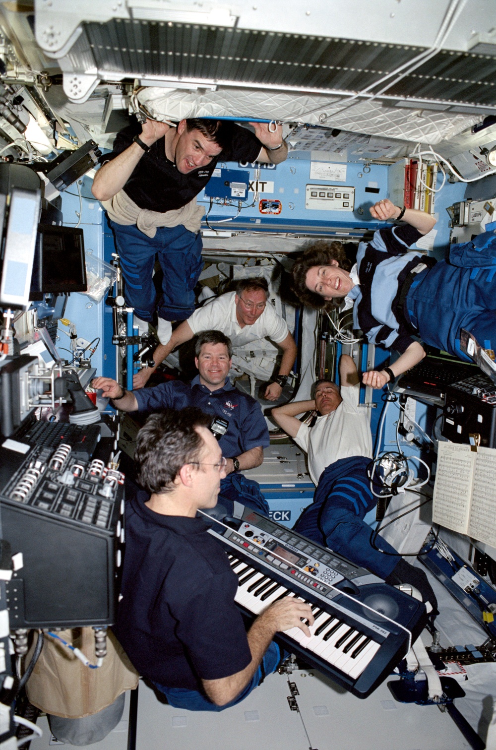 Carl Walz plays the piano in the U.S. Laboratory during STS-110