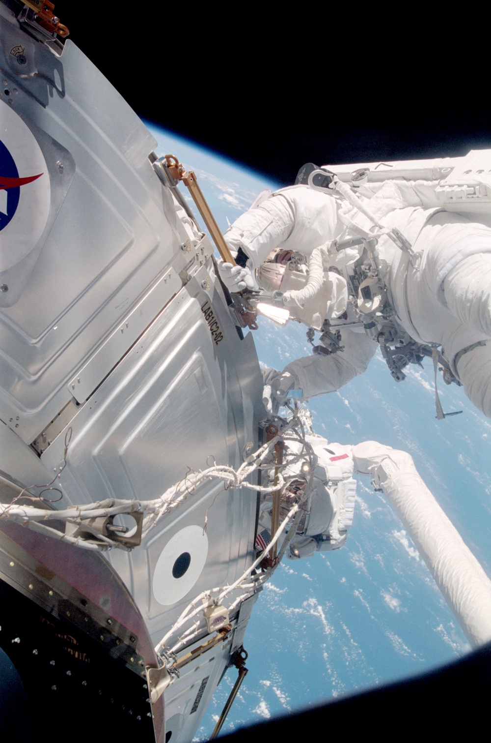 Forrester working with S0 cables on the LAB during EVA2