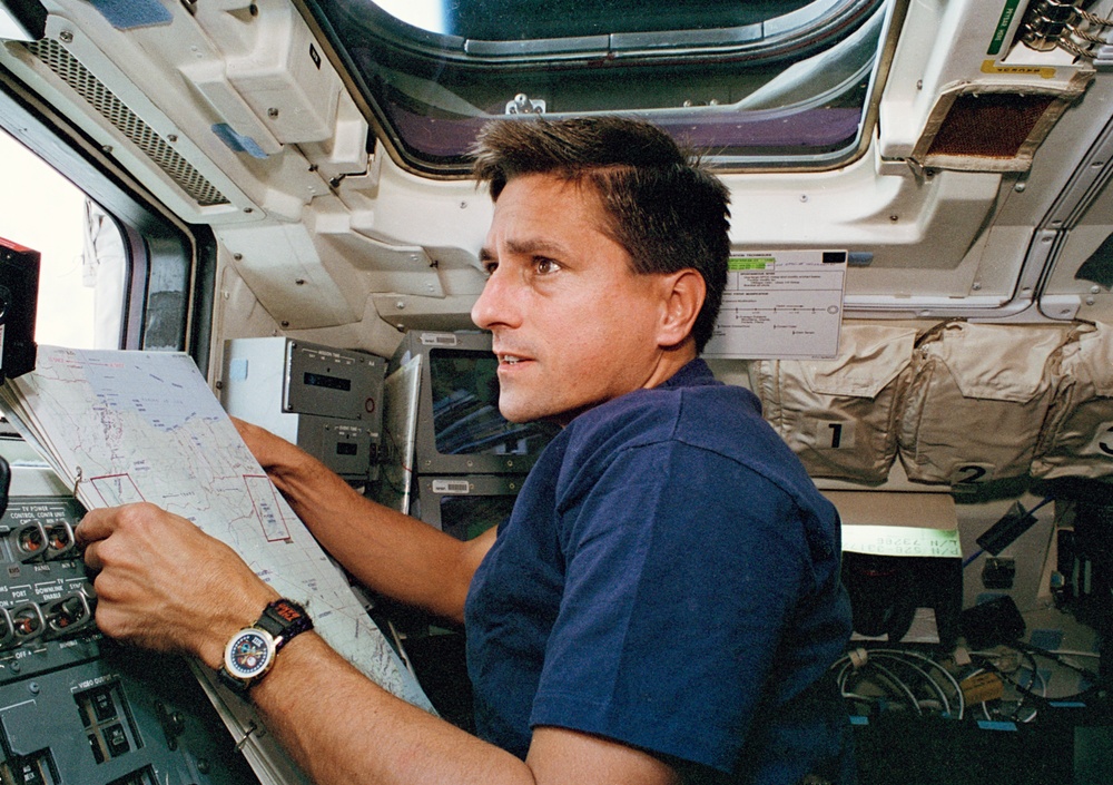 Thomas on flight deck with map