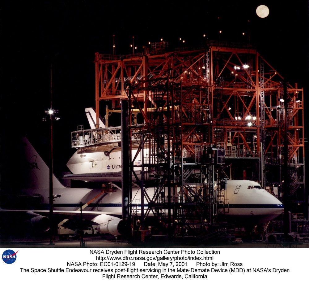 The Space Shuttle Endeavour receives post-flight servicing in the Mate-Demate Device (MDD) at NASA's