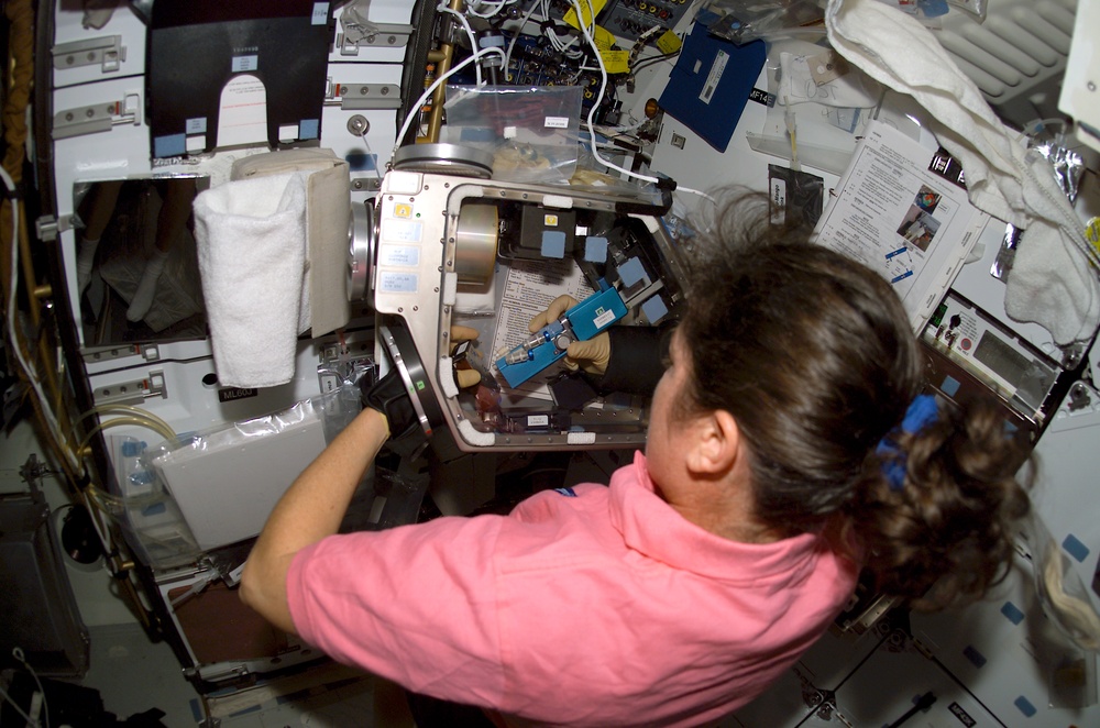 Clark works with the Biopack glovebox on the MDK during STS-107
