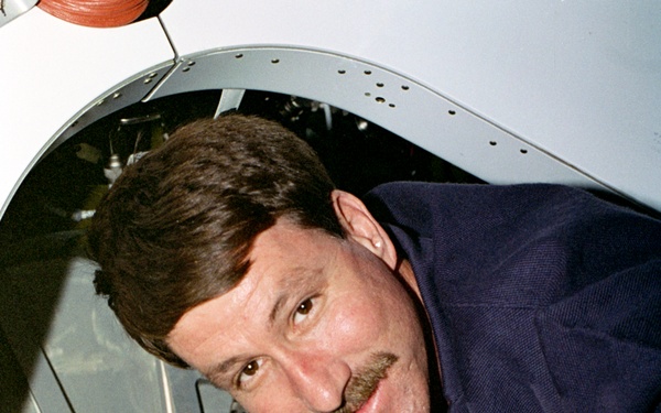 CDR Rominger beside one of the CBM hatches on the Node 1/Unity module