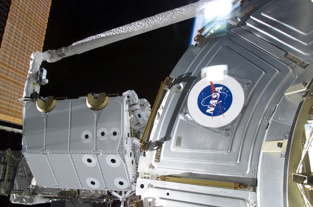 View of the RMS grappling the Spacelab Pallet during STS-100