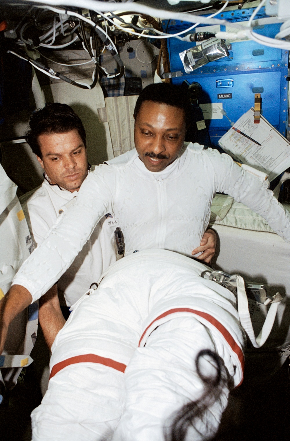 Scott and Doi conduct EMU suit up activities in preparation for second EVA