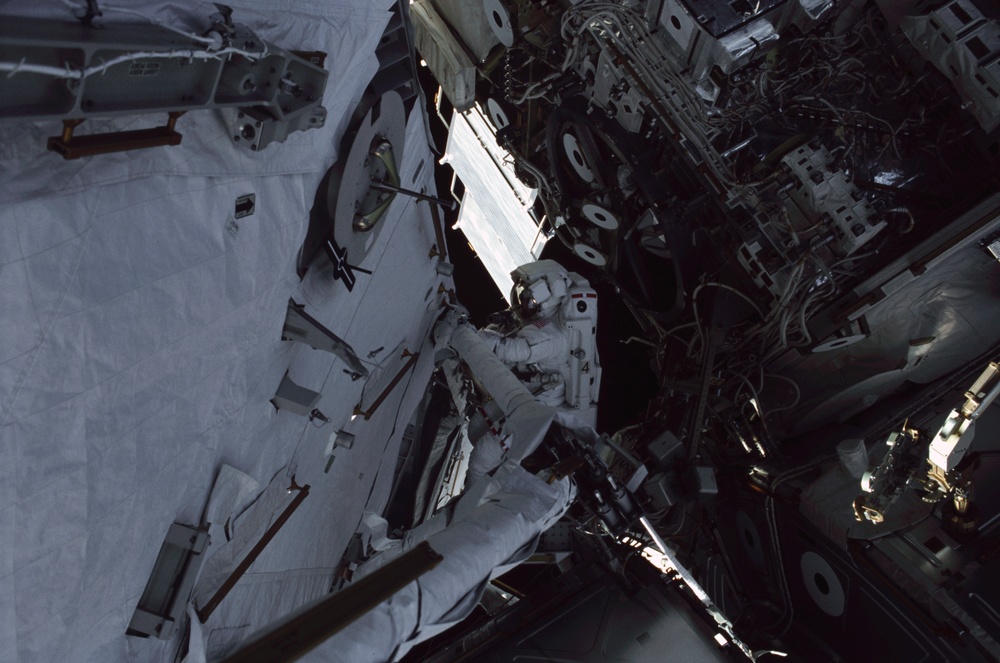 MS Ross works on the aft port struts for the S0 Truss during the second EVA of STS-110