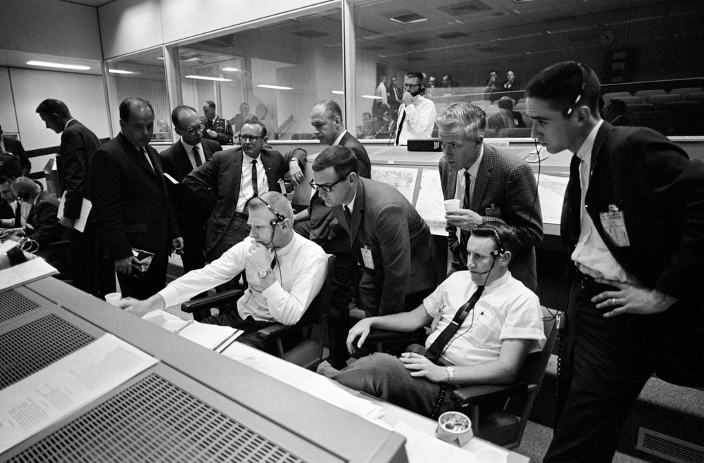 Personnel in Mission Control discuss the postponement of the Gemini 9 mission