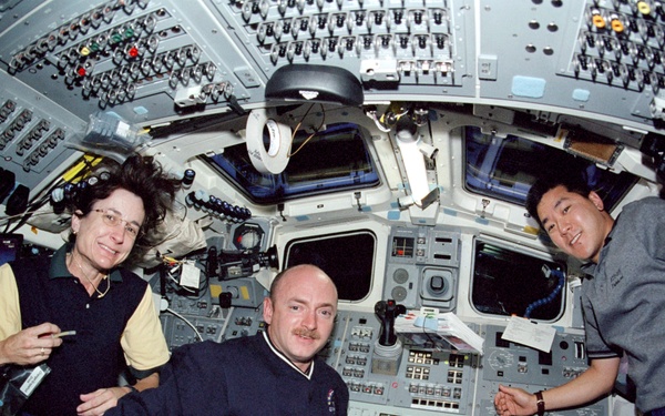 Tani, Godwin and Kelly pose on the flight deck during STS-108