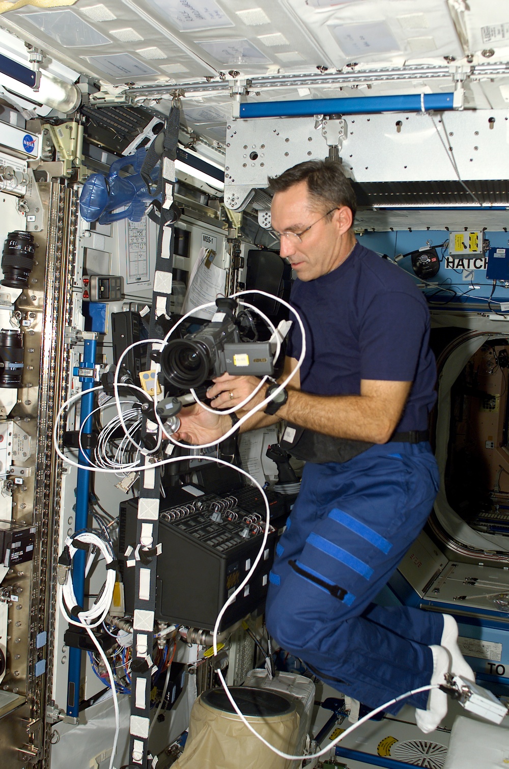 Flight Engineer Walz sets up a video camera in Destiny during STS-108's visit to the ISS