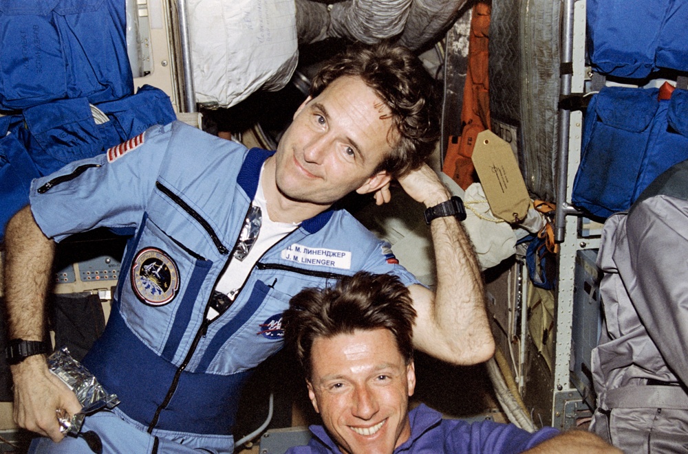 STS-84 and Mir 23 crewmembers interact in the Mir Space Station Base Block