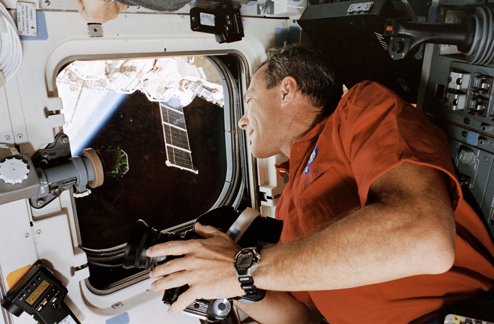 STS-79 crew at aft flight deck overhead windows with Mir in background